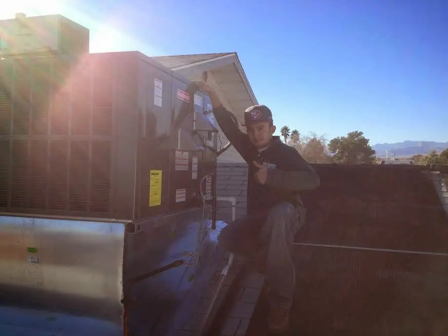 HVAC technician performing Boiler Repair on a rooftop unit in Hanover